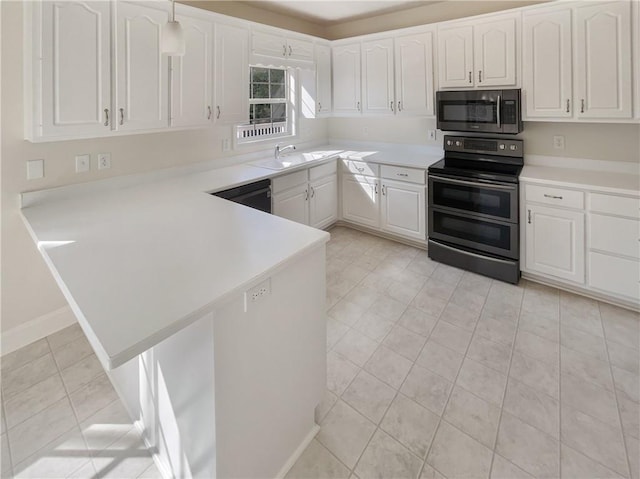 kitchen with a sink, a peninsula, white cabinets, range with two ovens, and dishwashing machine