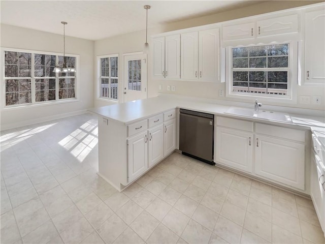 kitchen featuring dishwasher, light countertops, a peninsula, white cabinets, and a sink