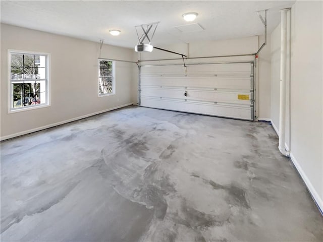 garage featuring a garage door opener and baseboards