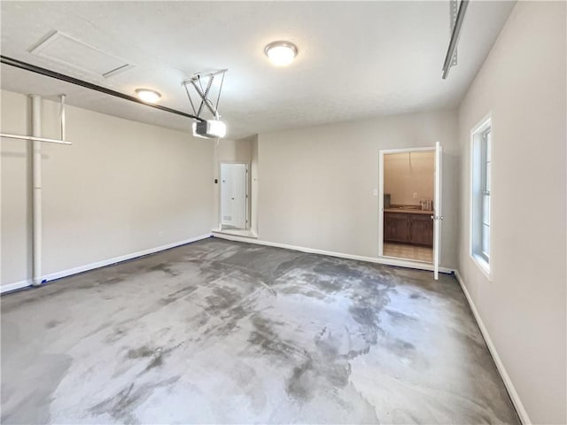 garage with baseboards and a garage door opener