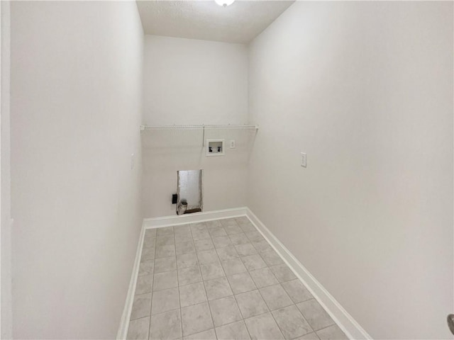 clothes washing area with baseboards, washer hookup, and laundry area