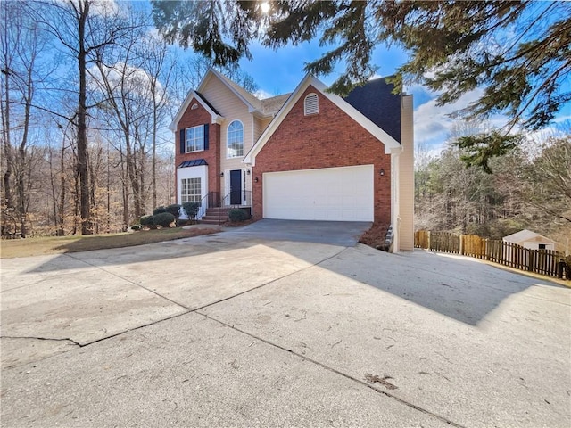 traditional-style house featuring fence, driveway, an attached garage, a chimney, and brick siding