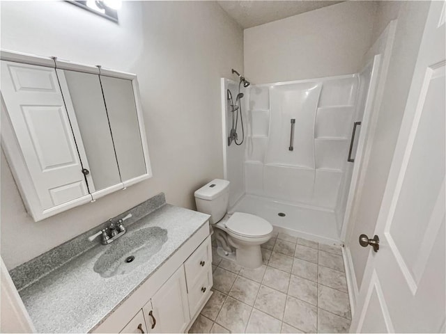 full bathroom with vanity, toilet, a stall shower, and tile patterned flooring