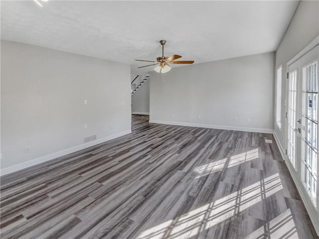 unfurnished room with visible vents, baseboards, stairway, french doors, and a ceiling fan