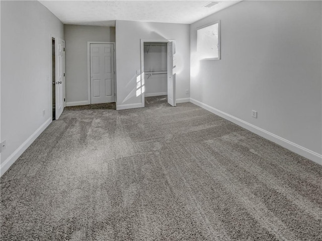 unfurnished bedroom with a closet, baseboards, and carpet floors