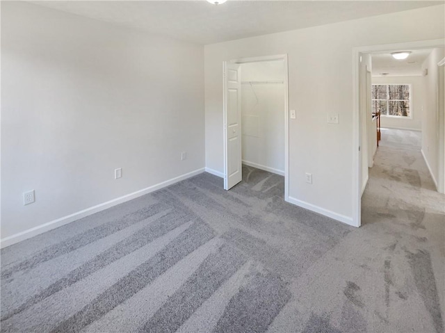 unfurnished bedroom with a closet, baseboards, and carpet