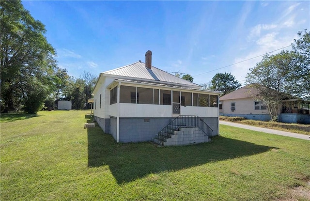 exterior space with a front lawn and a sunroom