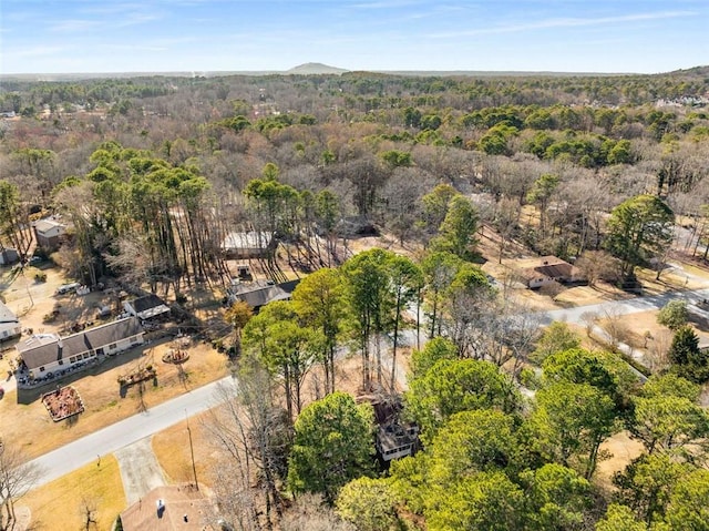 bird's eye view featuring a wooded view