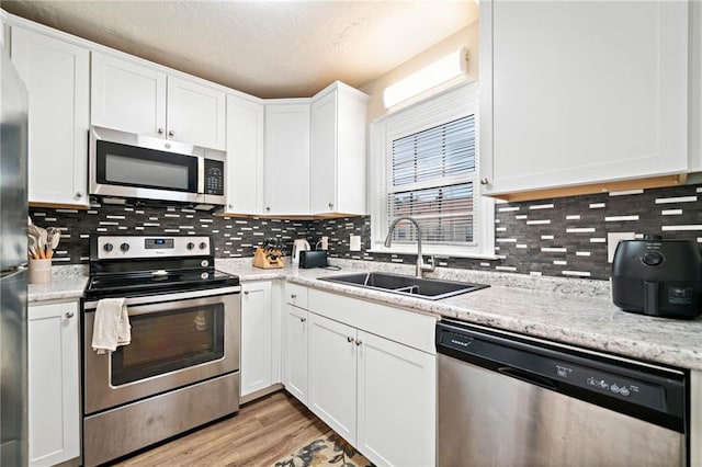 200 High Creek Dr, Roswell, GA 30076 - kitchen featuring tasteful backsplash, appliances with stainless steel finishes, a sink, and white cabinetry