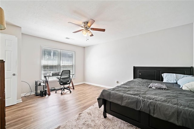 200 High Creek Dr, Roswell, GA 30076 - bedroom featuring a textured ceiling, a ceiling fan, visible vents, wood finished floors, and baseboards