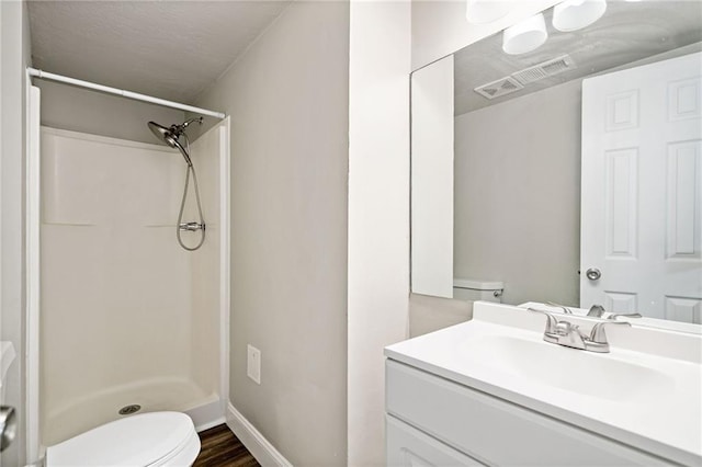200 High Creek Dr, Roswell, GA 30076 - bathroom featuring vanity, toilet, visible vents, a shower, and wood finished floors