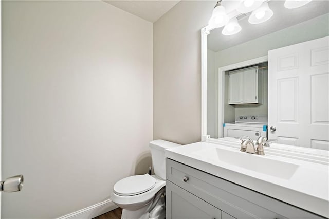 200 High Creek Dr, Roswell, GA 30076 - half bathroom featuring washer / clothes dryer, baseboards, toilet, vanity, and wood finished floors