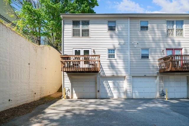 200 High Creek Dr, Roswell, GA 30076 - back of property featuring an attached garage and driveway