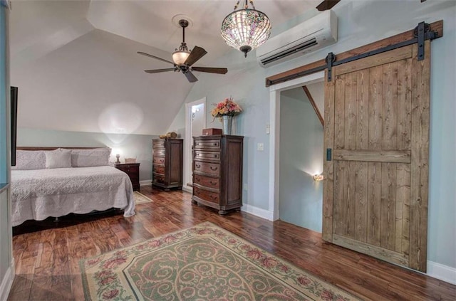 bedroom featuring dark hardwood / wood-style floors, lofted ceiling, a barn door, and a wall unit AC