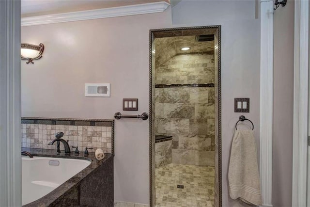 bathroom with ornamental molding and independent shower and bath