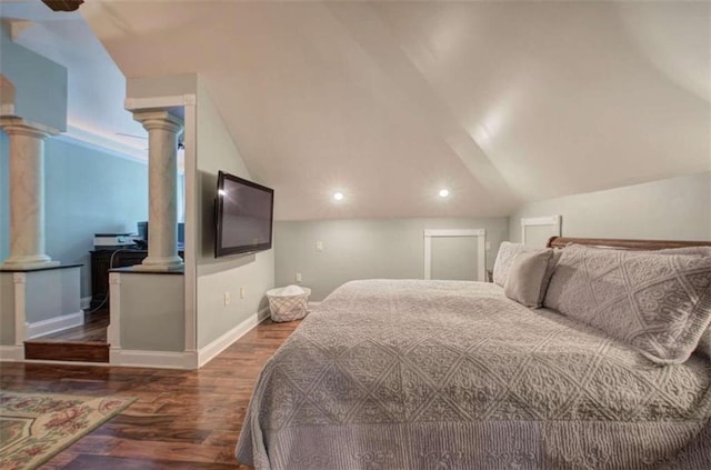 bedroom featuring lofted ceiling and dark hardwood / wood-style flooring