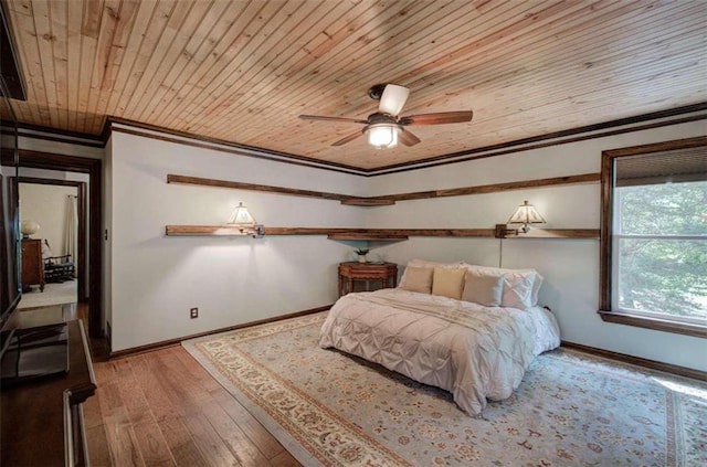 bedroom with ornamental molding, hardwood / wood-style flooring, wooden ceiling, and ceiling fan