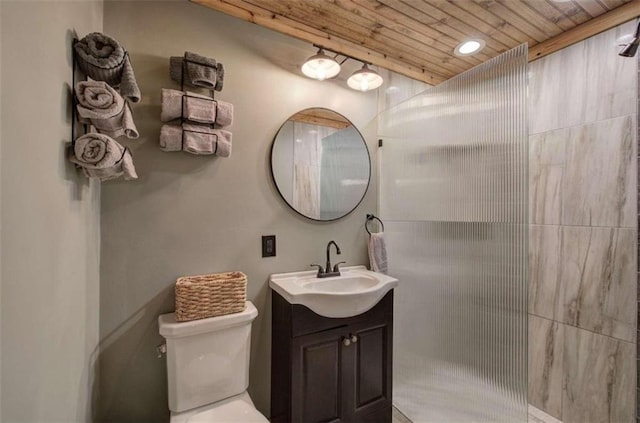 bathroom featuring vanity, toilet, a shower, and wooden ceiling