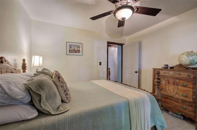 bedroom with a textured ceiling, carpet flooring, and ceiling fan