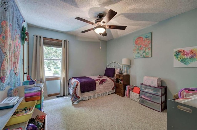 carpeted bedroom with ceiling fan and a textured ceiling