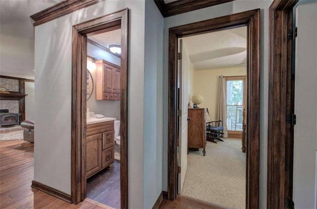 hallway featuring light hardwood / wood-style flooring and ornamental molding