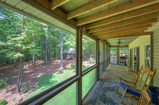 unfurnished sunroom featuring vaulted ceiling and a wealth of natural light