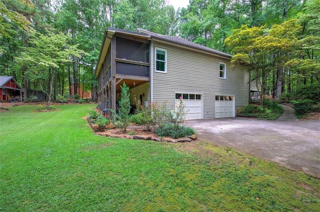 view of side of property with a yard and a garage