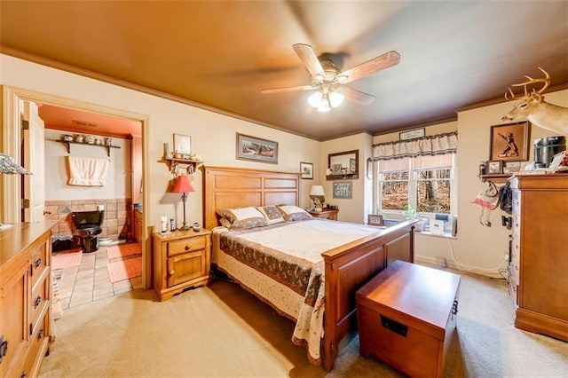 carpeted bedroom featuring ornamental molding and ceiling fan