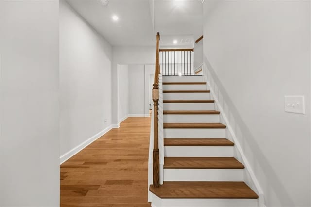 stairway featuring wood-type flooring