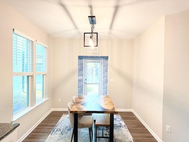dining space featuring baseboards and dark wood-style floors