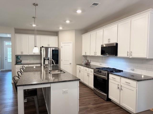 kitchen with a sink, beverage cooler, stainless steel appliances, dark wood-type flooring, and visible vents
