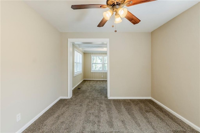 unfurnished room with baseboards, carpet, and a ceiling fan