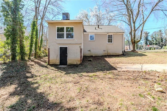 back of house with brick siding and crawl space