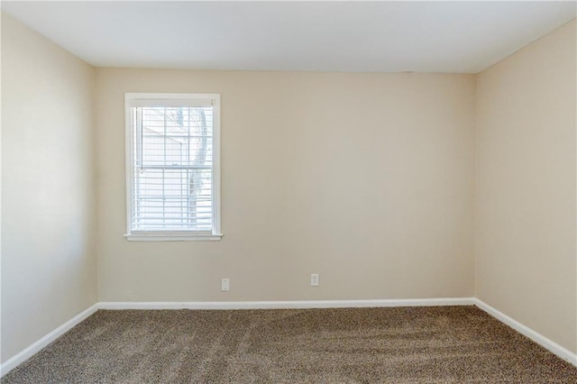 carpeted empty room with baseboards