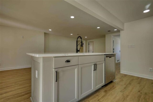 room details featuring light stone counters and sink