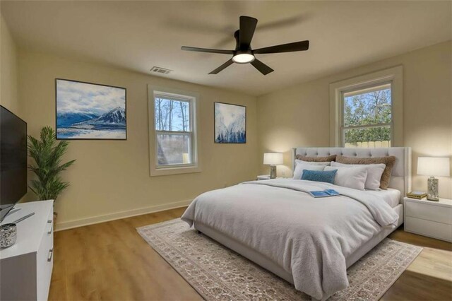 unfurnished bedroom featuring light hardwood / wood-style floors, ceiling fan, and ensuite bathroom