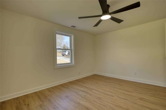 spare room featuring light hardwood / wood-style flooring and ceiling fan