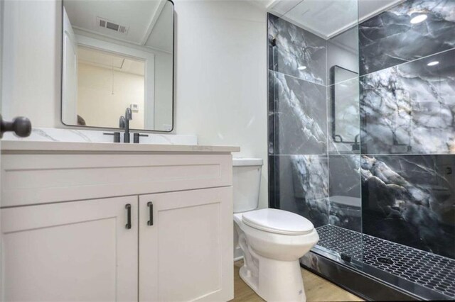 clothes washing area with water heater, hookup for a washing machine, and light hardwood / wood-style flooring