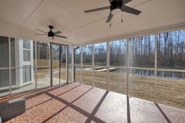 unfurnished sunroom with ceiling fan