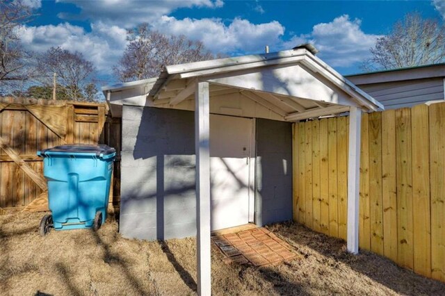 view of side of property featuring a shed