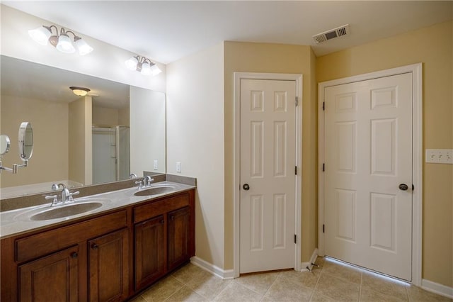 4400 Village Field Pl, Suwanee, GA 30024 - bathroom with double vanity, baseboards, and tile patterned flooring