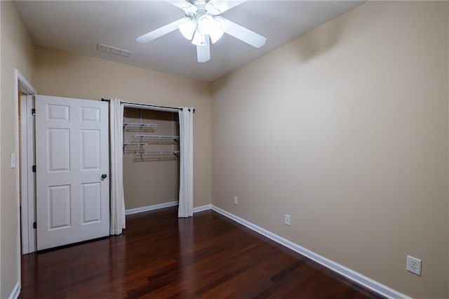 4400 Village Field Pl, Suwanee, GA 30024 - unfurnished bedroom featuring baseboards, dark wood-style flooring, a closet, and ceiling fan