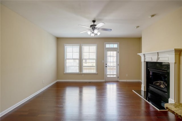 4400 Village Field Pl, Suwanee, GA 30024 - unfurnished living room featuring ceiling fan, dark wood-style floors, a glass covered fireplace, and baseboards
