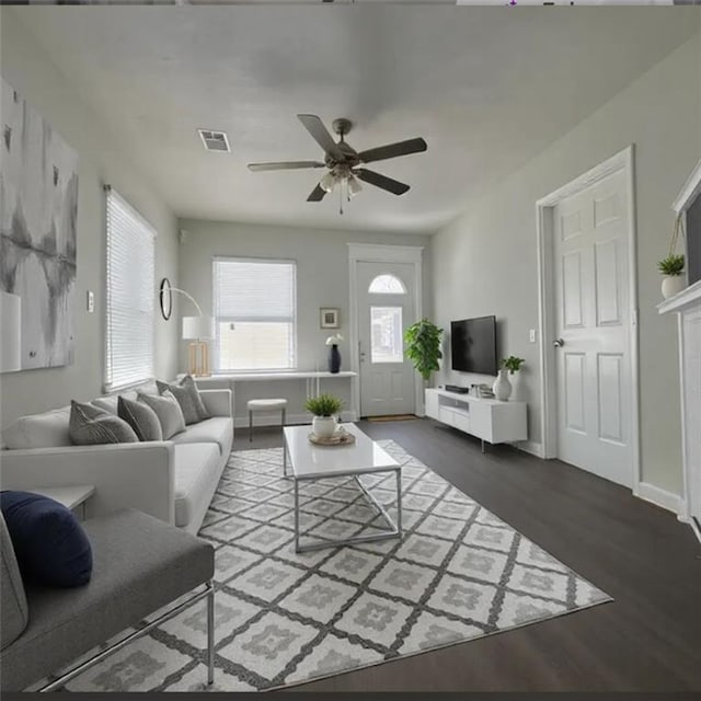 living room with dark wood-type flooring and ceiling fan