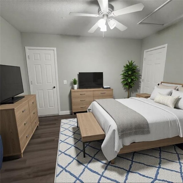 bedroom with dark hardwood / wood-style flooring, a textured ceiling, and ceiling fan