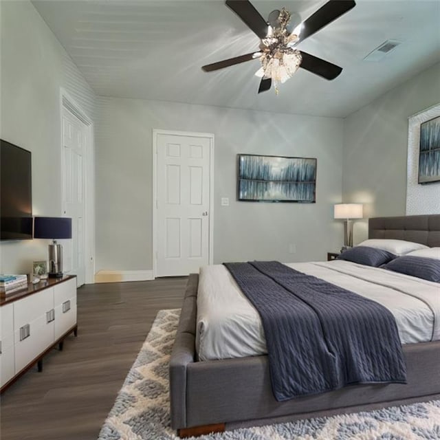 bedroom with dark wood-type flooring and ceiling fan