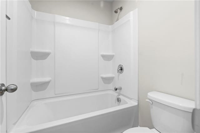 bathroom with toilet and bathing tub / shower combination