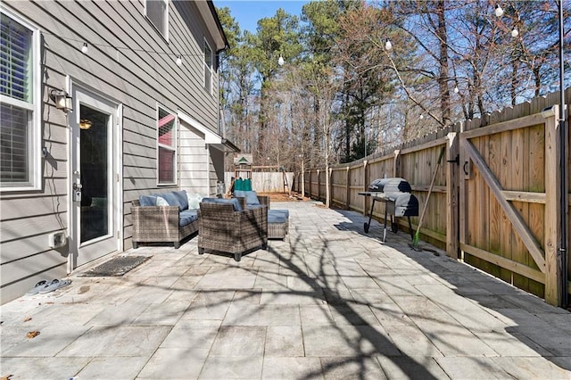 view of patio / terrace with a gate, outdoor lounge area, and a fenced backyard