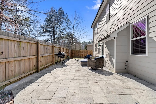 view of patio featuring a fenced backyard, outdoor lounge area, and grilling area