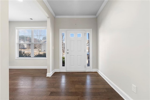 foyer with baseboards, visible vents, ornamental molding, and dark wood-style flooring